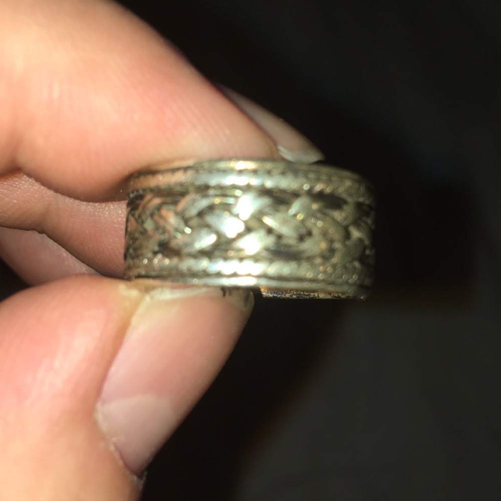 Silver ring with braided design.